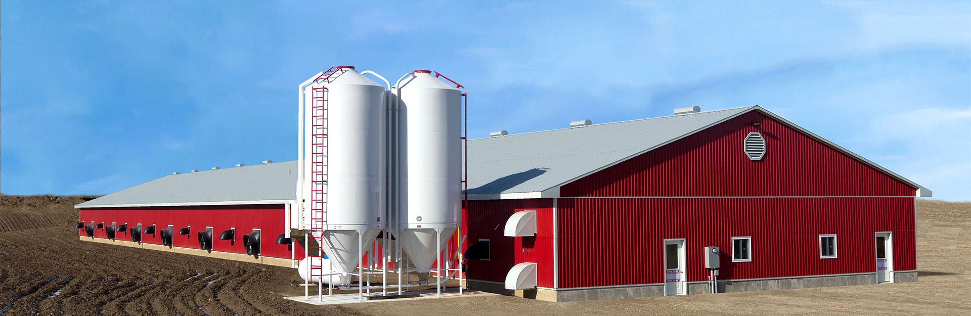 red barn with wooden fence around yard